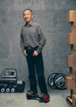 Shane Chen standing on the original Hoverboard
